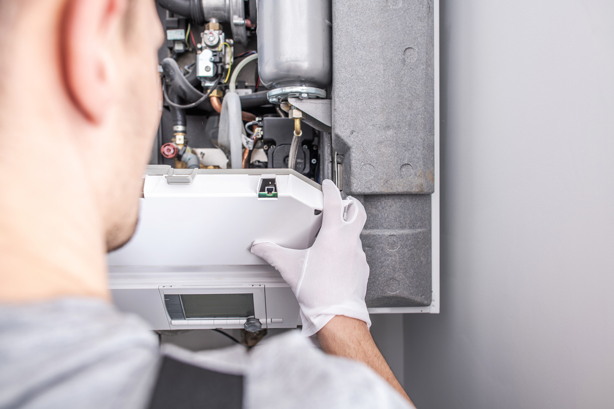 HVAC technician repairing a Southeast Michigan home's furnace