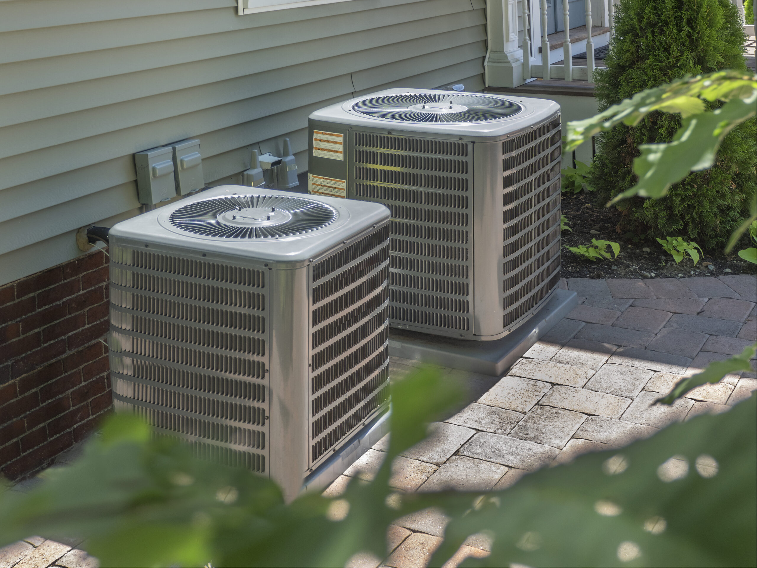 Dual AC unit outside home on patio